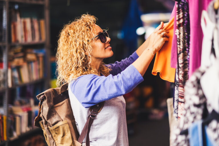 Cheerful traveler young blonde curly woman looking and choosing